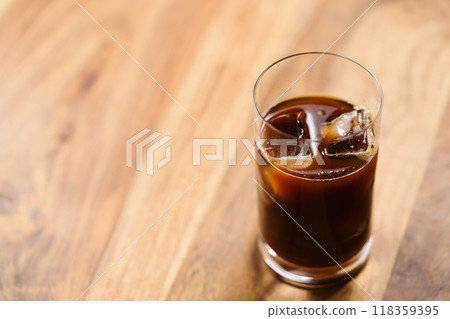 Glass of iced coffee on wooden table Glass of iced coffee on wooden table 118359395