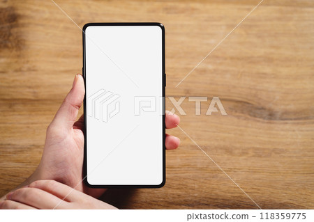 female teen hand holding smartphone with blank white screen 118359775