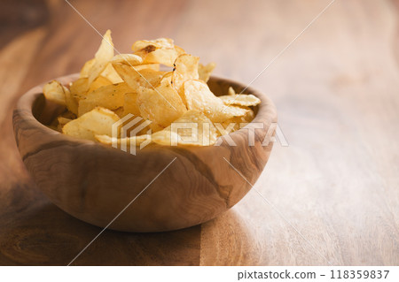 organic potato chips with herbs in bowl on wood table organic potato chips with herbs in bowl on wood table 118359837