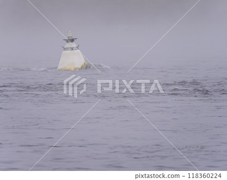 White buoy on a morning foggy river. White buoy on a morning foggy river. 118360224
