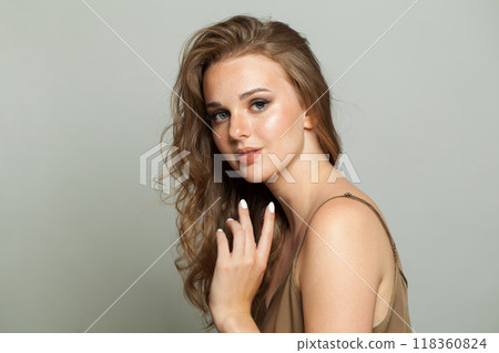 Pretty smiling young adult woman studio photo 118360824