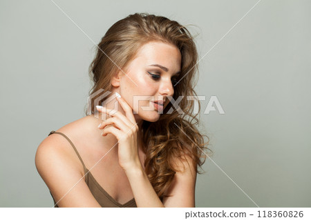 Glamorous young lady with makeup and long wavy hair, closeup portrait. Beautiful woman 118360826