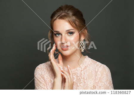 Cheerful female model with healthy skin, natural makeup and perfect updo hairstyle Cheerful female model with healthy skin, natural makeup and perfect updo hairstyle 118360827