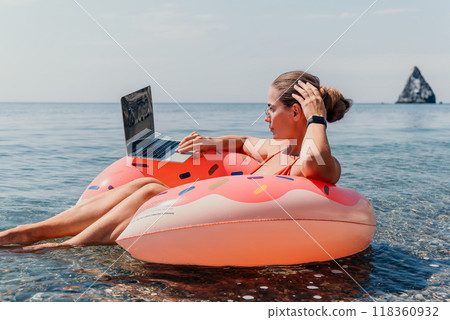 Woman Laptop Beach Relaxing on Inflatable Float in Ocean 118360932
