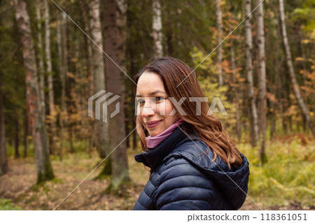Beautiful woman walking in autumn park outdoor Beautiful woman walking in autumn park outdoor 118361051