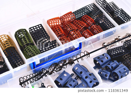 Feeder troughs of different colors and sizes in a plastic box for accessory close-up 118361349