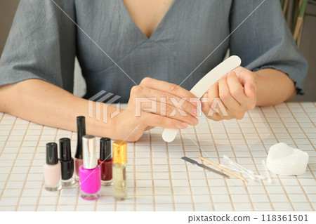 woman gets manicure at home, taking care of her nails and hands. manicure process woman gets manicure at home, taking care of her nails and hands. manicure process 118361501