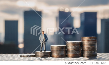 一個商人站在一堆硬幣上的微型人物。低收入男性。收入不平等的形象。 118361683