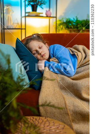 Tired teen child girl kid lying down in bed taking a rest at home, napping, falling asleep on sofa Tired teen child girl kid lying down in bed taking a rest at home, napping, falling asleep on sofa 118362230