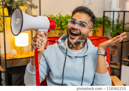 Indian man talking with megaphone, proclaiming news, loudly announcing advertisement promotion sale Indian man talking with megaphone, proclaiming news, loudly announcing advertisement promotion sale 118362233