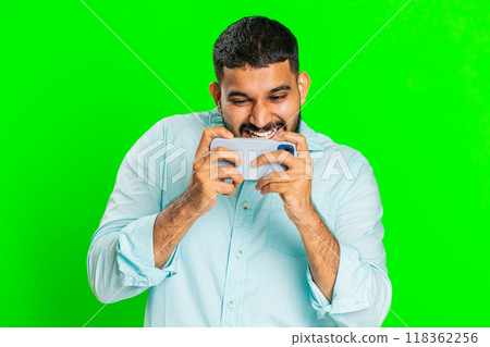 Happy man playing racing drive simulator, shooter video games on smartphone, celebrate victory win 118362256