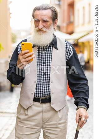 Senior man use smartphone typing text messages browsing internet finishing work chatting online Senior man use smartphone typing text messages browsing internet finishing work chatting online 118362265