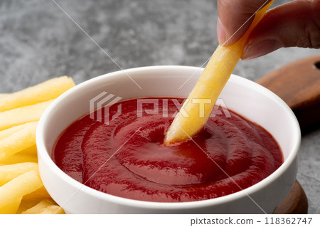 Close-up of french fries dipped in ketchup 118362747
