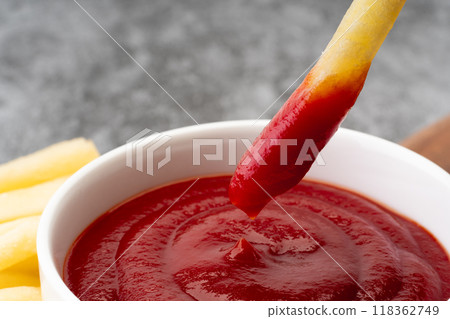 Close-up of french fries dipped in ketchup 118362749