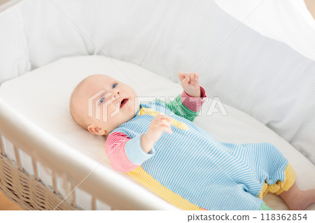 Cute baby boy in a white crib Cute baby boy in a white crib 118362854