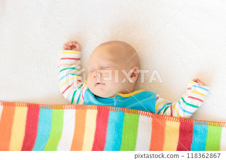 Little baby on white bed 118362867