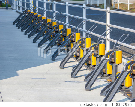 A flat-mounted bicycle rack installed in a bicycle parking lot at a commercial facility 118362956