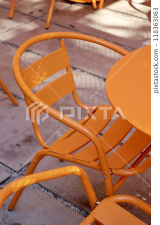 Coffee shop restaurant, orange furniture tables and chairs for guests. cozy street with cafe tables Coffee shop restaurant, orange furniture tables and chairs for guests. cozy street with cafe tables 118363063
