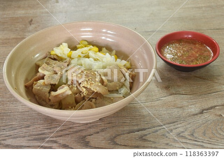 Korean fried slice pork with cabbage and glass noodles on bowl dipping spicy sauce Korean fried slice pork with cabbage and glass noodles on bowl dipping spicy sauce 118363397