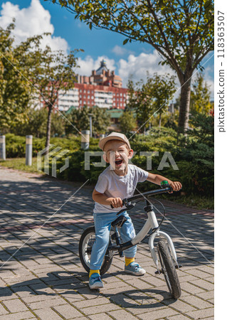 Very happy little boy on runner bike Very happy little boy on runner bike 118363507