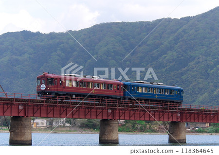 Kyoto Tango Railway's tourist trains "Akamatsu" and "Aomatsu" crossing the Yura River Bridge Kyoto Tango Railway's tourist trains "Akamatsu" and "Aomatsu" crossing the Yura River Bridge 118364645