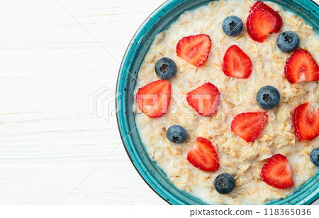 Homemade breakfast . Oatmeal with milk and berries . Top view Homemade breakfast . Oatmeal with milk and berries . Top view 118365036
