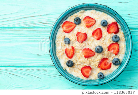 Homemade breakfast . Oatmeal with milk and berries . Top view Homemade breakfast . Oatmeal with milk and berries . Top view 118365037