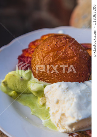 roasted peaches on an open fire with ice cream on a plate close up roasted peaches on an open fire with ice cream on a plate close up 118365206