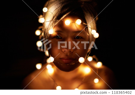 A cute girl taking photos indoors using LED lights A cute girl taking photos indoors using LED lights 118365402