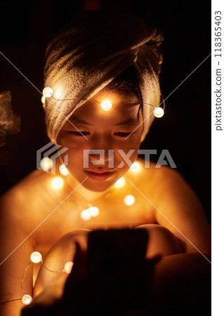 A cute girl taking photos indoors using LED lights A cute girl taking photos indoors using LED lights 118365403