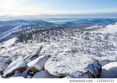 Big stones and sparse coniferous forest, snowy winter valley in the mountains. Nature landscape panorama Big stones and sparse coniferous forest, snowy winter valley in the mountains. Nature landscape panorama 118365533