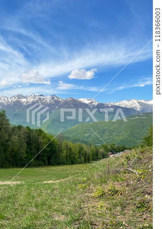 Beautiful panoramic landscape - view of Glade 960 with modern luxury hotels among the green mountains on a sunny summer day 118366003