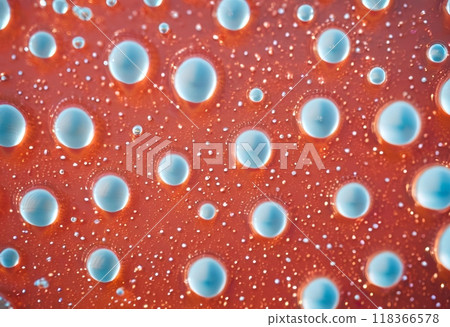 Translucent jelly blobs scattered on reddish surface.AI Generated 118366578