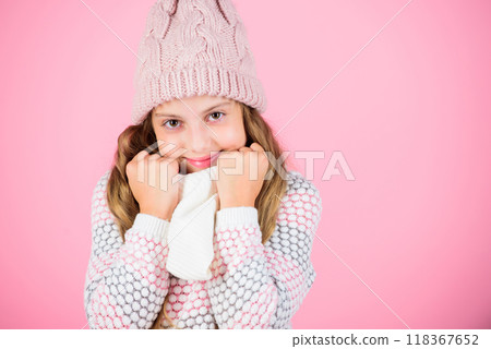 Winter fashion warm clothes concept. Warm accessories that will keep you cozy winter. Child long hair warm woolen hat enjoy warm and softness. Kid girl wear knitted warm hat relaxing pink background Winter fashion warm clothes concept. Warm accessories that will keep you cozy winter. Child long hair warm woolen hat enjoy warm and softness. Kid girl wear knitted warm hat relaxing pink background 118367652