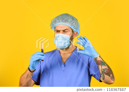 medical scientist hold test tubes. doctor wearing surgical mask while testing. nurse examines blood samples in lab. what is coronavirus. medicine against new type of virus influenza. epidemic 118367887