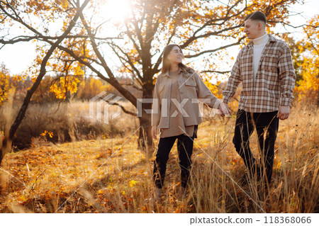 Stylish couple walking and enjoying autumn weather. People, lifestyle, vacations concept. Autumn. Stylish couple walking and enjoying autumn weather. People, lifestyle, vacations concept. Autumn. 118368066