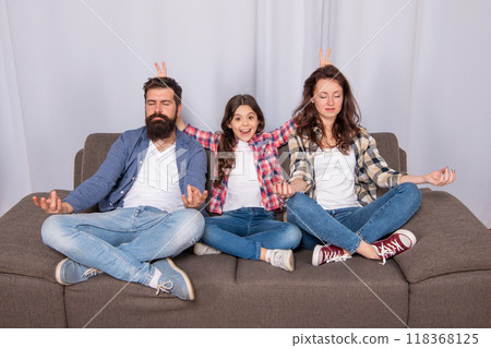 father mother and child on sofa. friendly family having fun. happy parents with kid girl 118368125