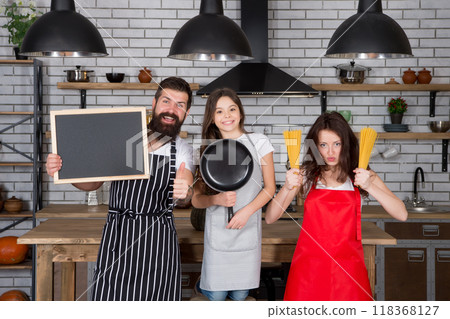 professional chef. recipe of happiness. Healthy lifestyle. Cooking at home. Preparing food. kid chef cook dinner with parents. mom and dad with daughter child preparing meal. happy family in kitchen 118368127