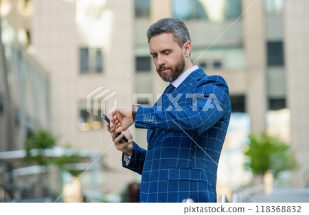 Punctual man check time on watch being late. Businessman with watch. Punctual businessman waiting and checking time outdoor. Business deadline. Businessman late for business deadline. Time management 118368832