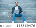 photo of freelance man sitting with computer. freelance man with laptop outdoor. 118369476