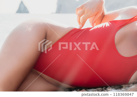 Woman in Red Swimsuit Relaxing on the Beach Woman in Red Swimsuit Relaxing on the Beach 118369847