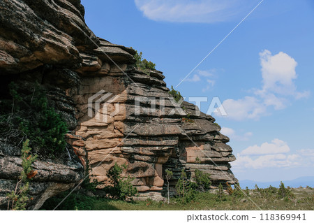Low syenite rock igneous mountain formation. cooled layers of magma. Natural Climbing training area in forest Low syenite rock igneous mountain formation. cooled layers of magma. Natural Climbing training area in forest 118369941