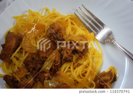The photo shows an appetizing plate of spaghetti, generously covered with fragrant tomato sauce. The pasta threads look perfectly cooked: they gently sparkle, and their golden color promises a unique The photo shows an appetizing plate of spaghetti, generously covered with fragrant tomato sauce. The pasta threads look perfectly cooked: they gently sparkle, and their golden color promises a unique 118370741