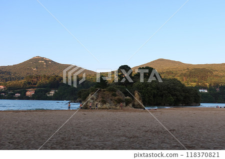 San Antonio Beach in Basque Country, Spain: Sandy Shore, Sea, and Mountain Peaks San Antonio Beach in Basque Country, Spain: Sandy Shore, Sea, and Mountain Peaks 118370821