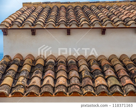 Traditional Mediterranean style terracotta roof with curved, clay tiles 118371163