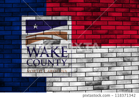 Flag of the city of Wake County, North Carolina, USA, on a background of the stone wall. Conceptual collage 118371342
