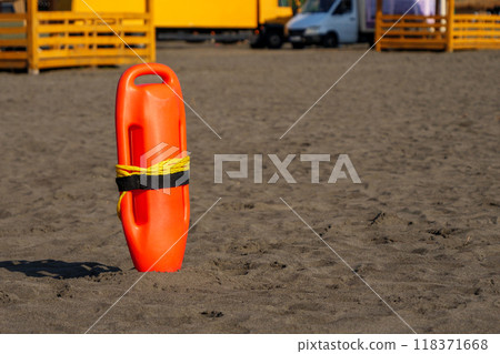 Lifeguard buoy placed in the sandy beach during a sunny day Lifeguard buoy placed in the sandy beach during a sunny day 118371668