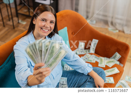 Successful happy rich business woman counting money cheering up with high profits lottery game win Successful happy rich business woman counting money cheering up with high profits lottery game win 118371687
