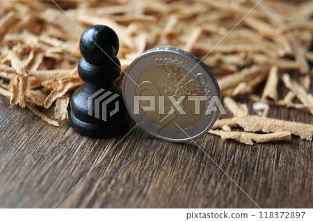 European currency. Chess pawn and 2 euro coin. European currency. Chess pawn and 2 euro coin. 118372897