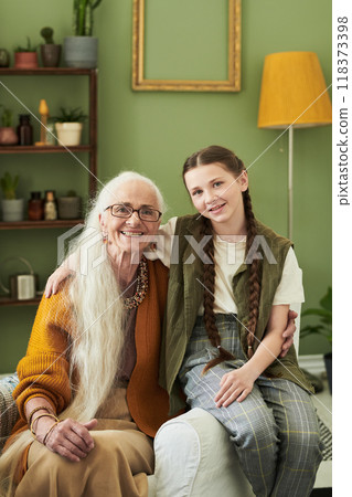 Elderly Woman Sitting with Granddaughter Smiling Happily Elderly Woman Sitting with Granddaughter Smiling Happily 118373398